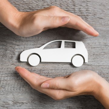axiom features moxa vehicle service contracts hands protecting white toy car 